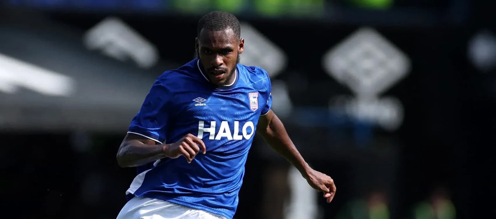 Player running in blue jersey during match