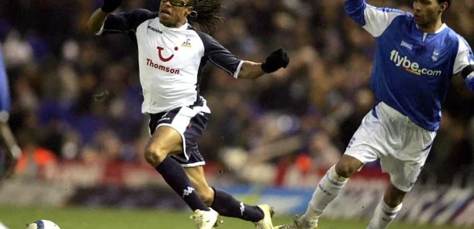 Player evading opponent during football match action