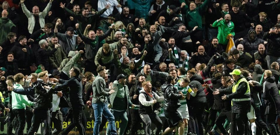 Fans celebrating during a football match on field