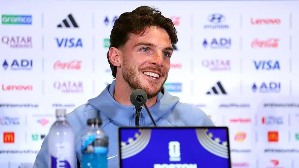Player speaking at press conference with microphones