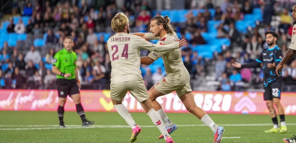 Players celebrating a goal during match