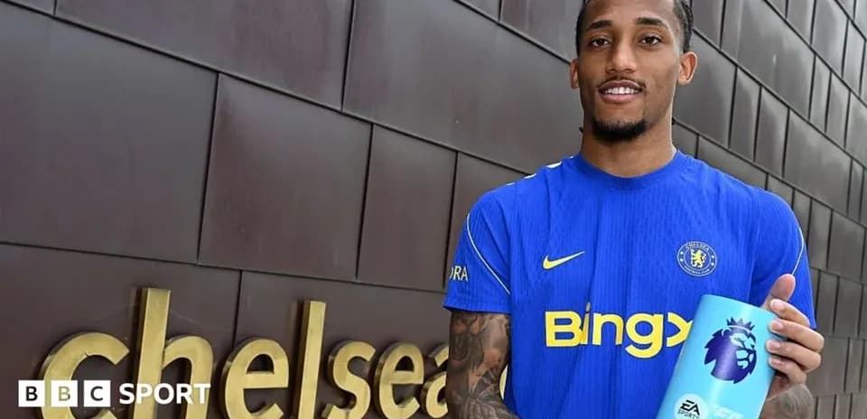 Player holding Premier League trophy at Chelsea venue
