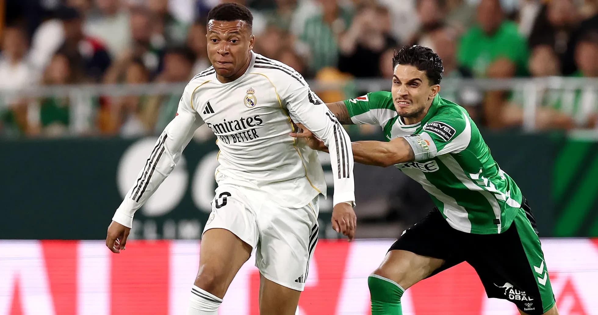 Player in white sprinting with opponent pulling shirt