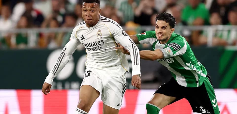 Player in white sprinting with opponent pulling shirt