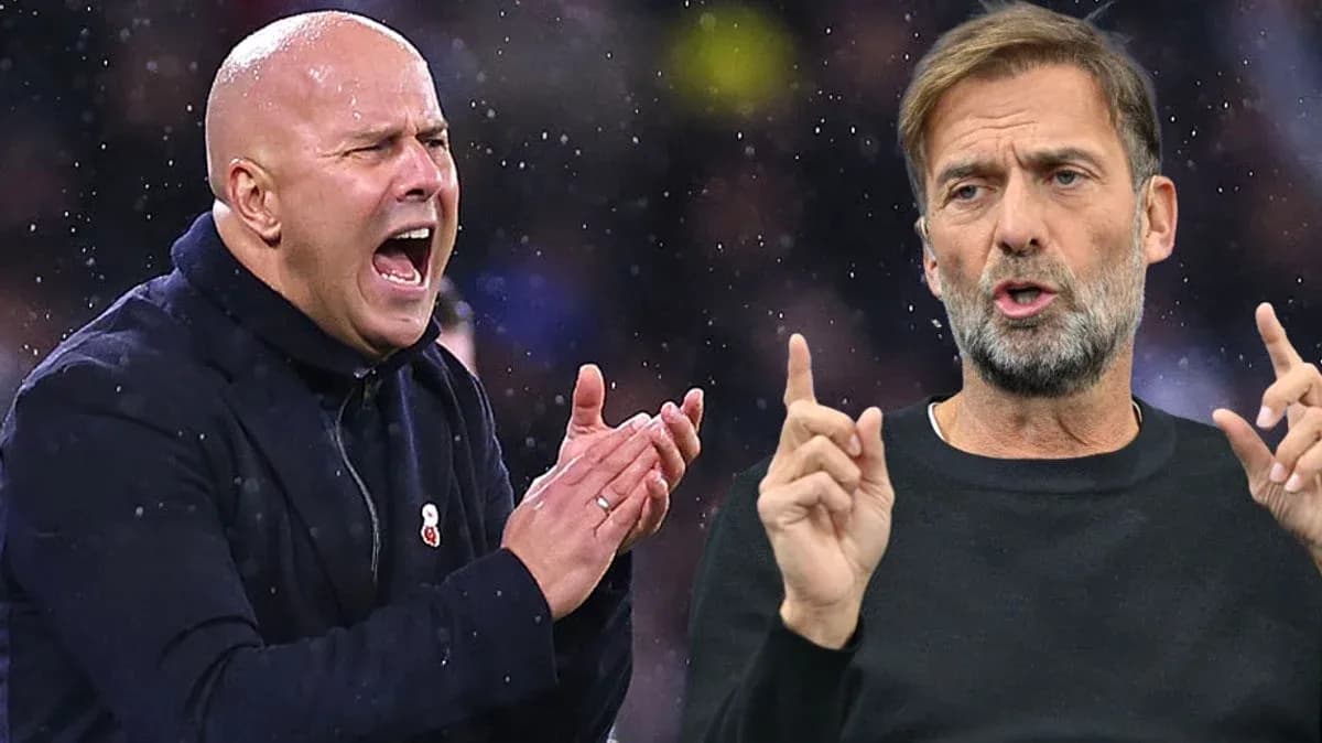 Two football managers discussing strategies during match
