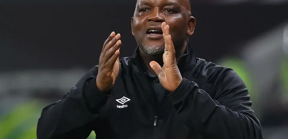Coach gesturing during a match from the sidelines