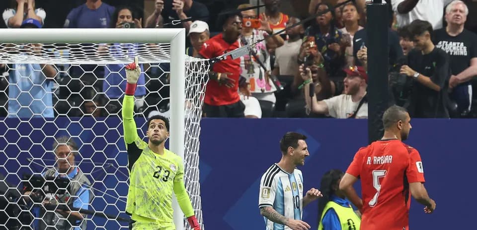 Goalkeeper celebrating a save with players nearby