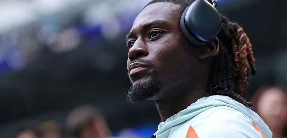 Player wearing headphones during pre-game preparations