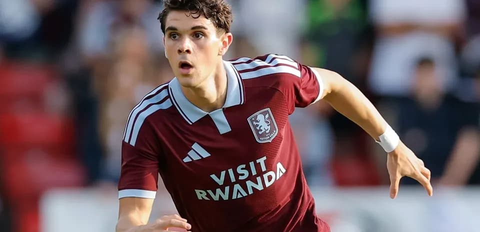 Player in Aston Villa kit running on the field