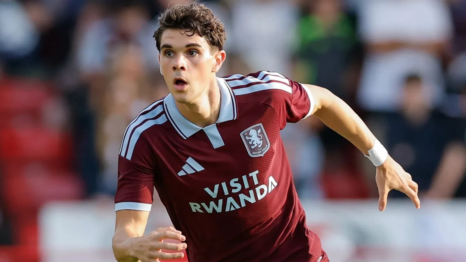 Player in Aston Villa kit running on the field