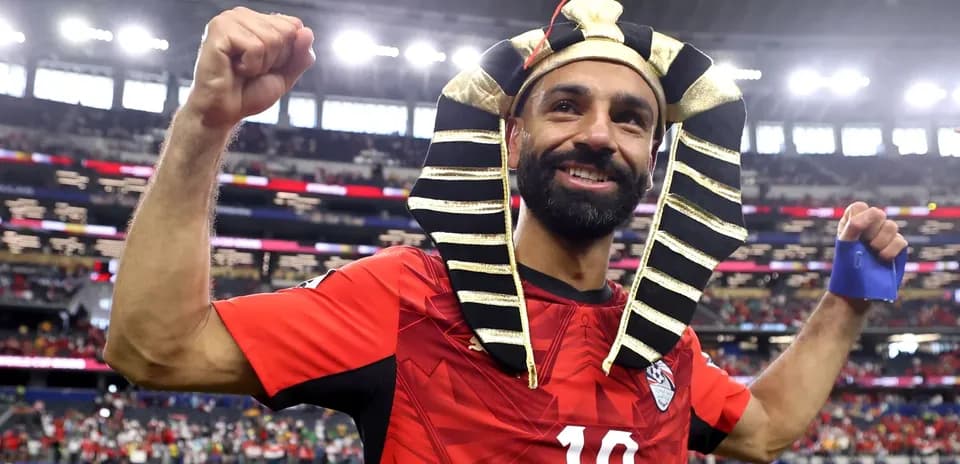 Player celebrating in Egyptian-themed headpiece after match
