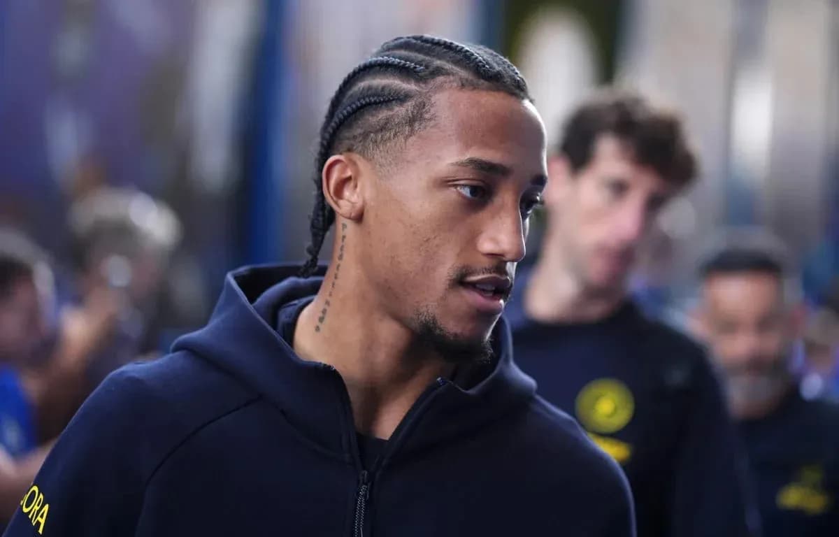 Player with braids walking in team hoodie