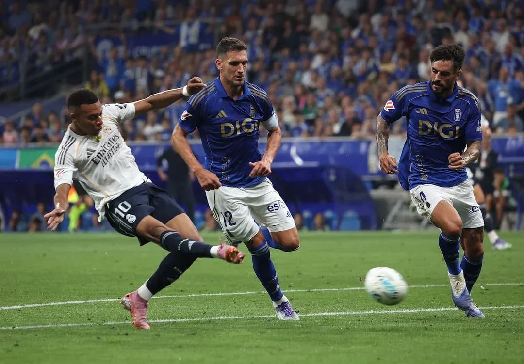 Real Madrid player kicking ball against Oviedo