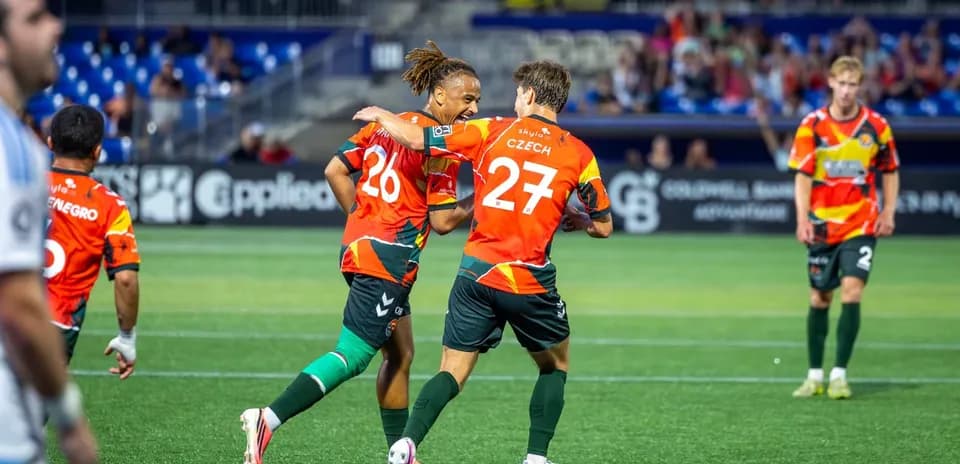 Players celebrating a goal during match