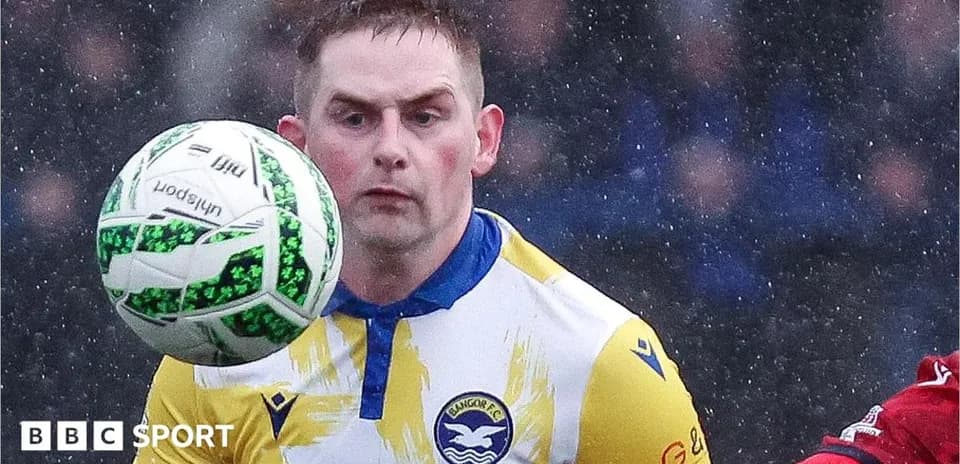 Player controlling the ball during a rainy match