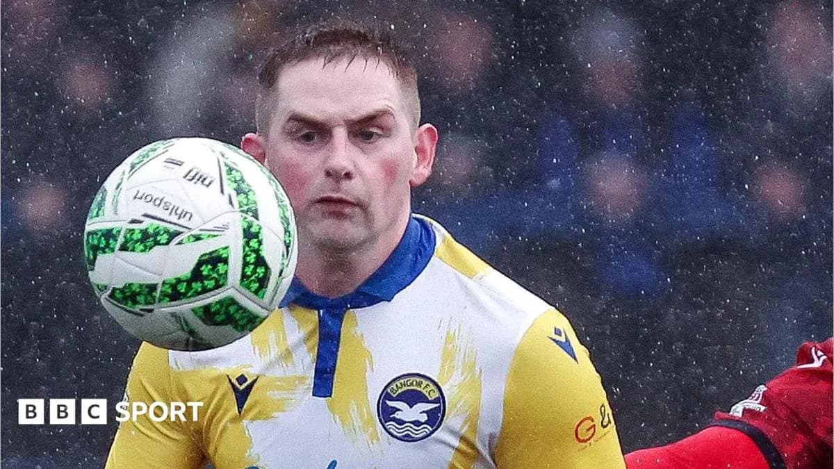 Player controlling the ball during a rainy match