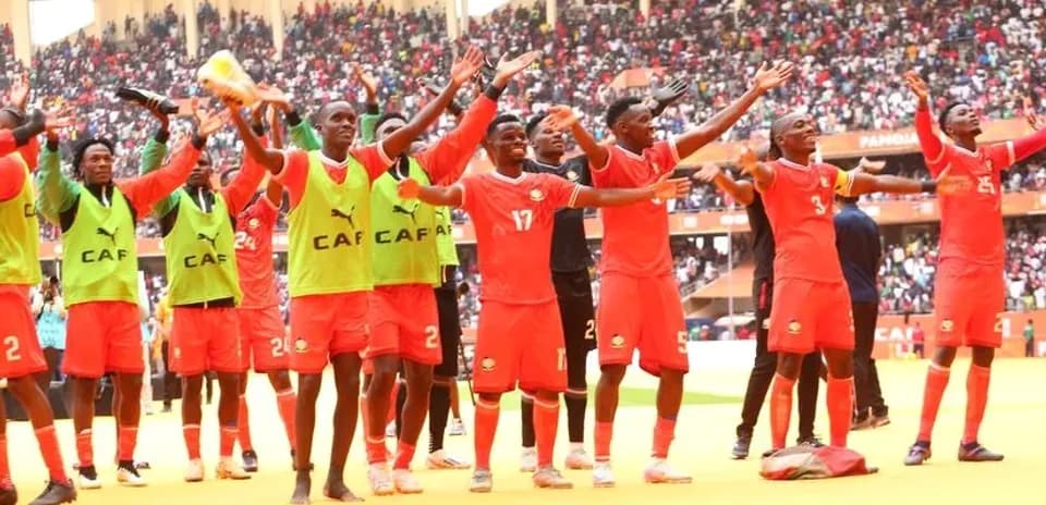Players celebrating with fans in packed stadium
