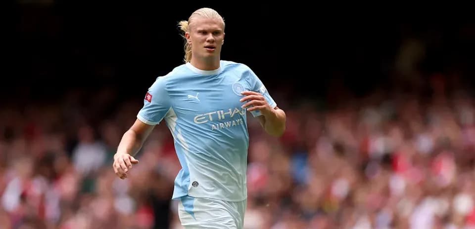 Player in light blue kit running on the pitch