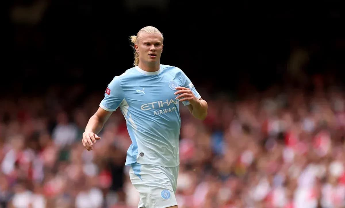 Player in light blue kit running on the pitch