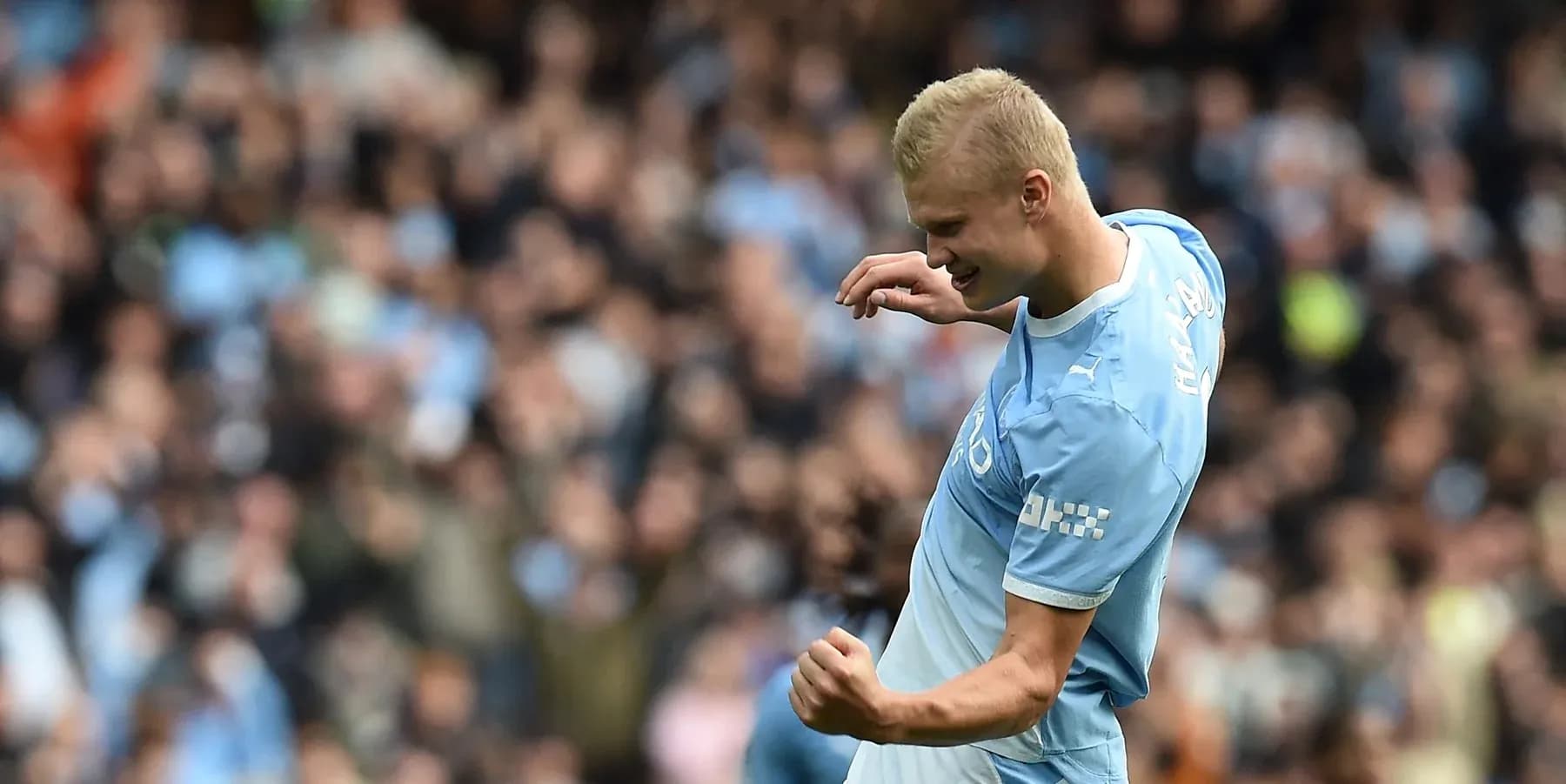 Player celebrating a goal with fans in background