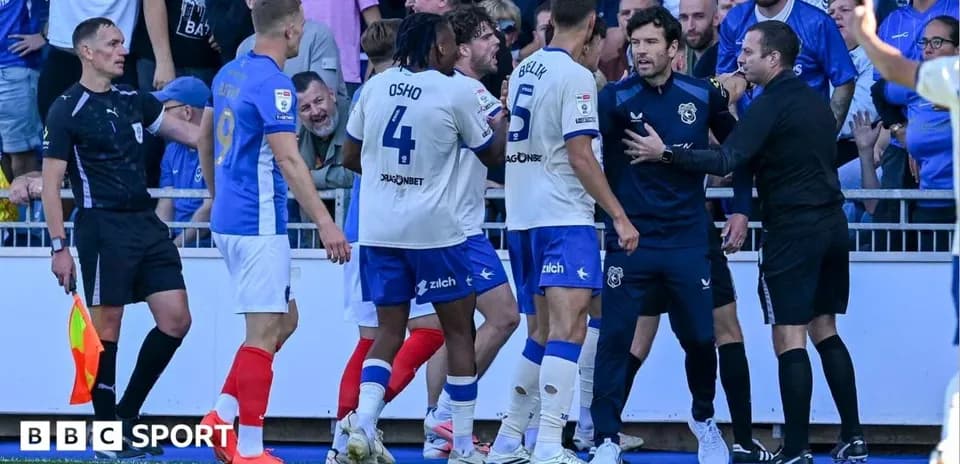 Players and officials in a heated discussion on pitch