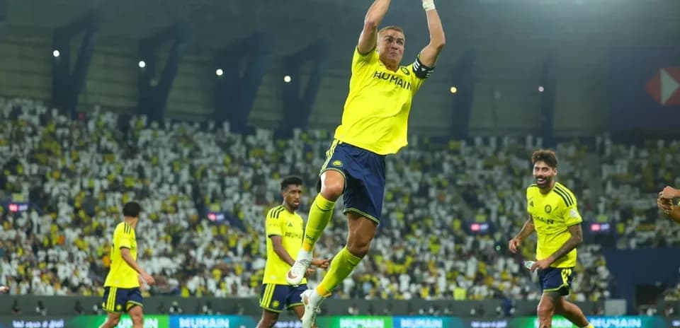 Player celebrating a goal with teammates on field