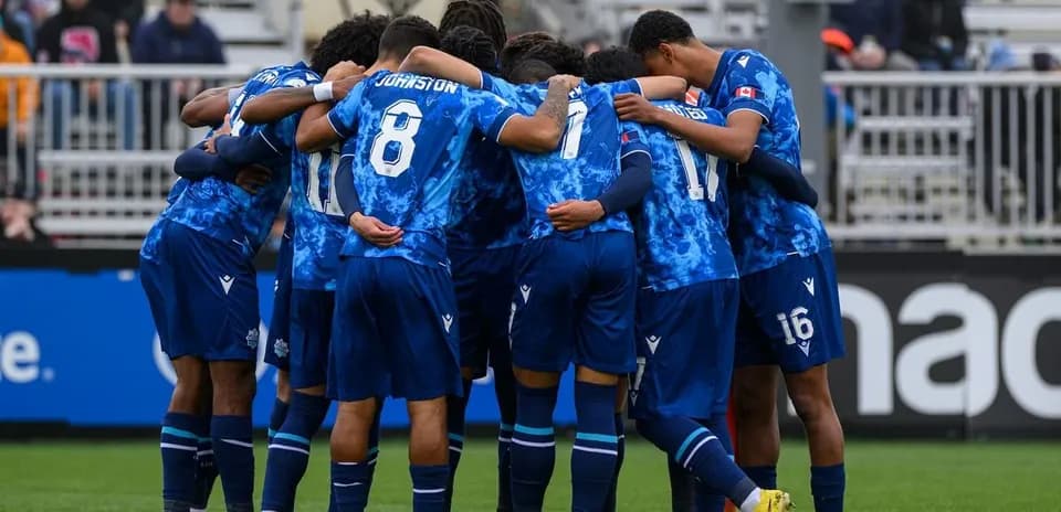 Cavalry FC players huddled before match