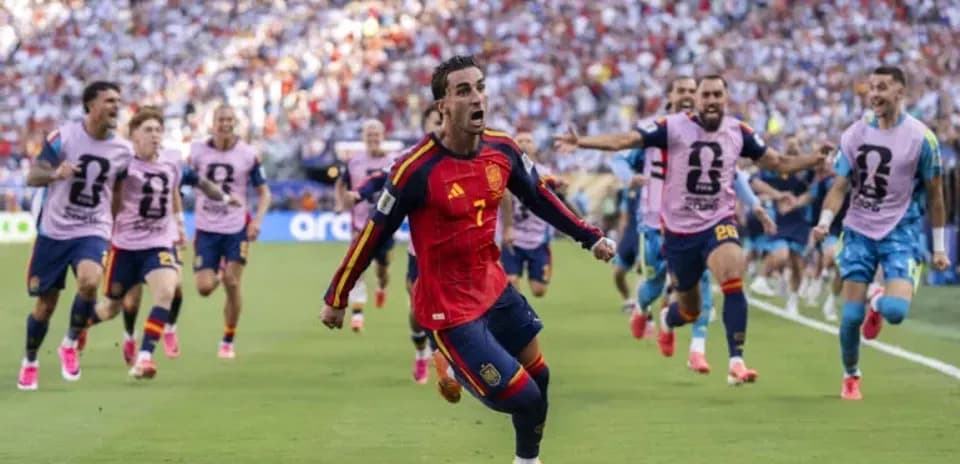 Spain player celebrating goal with teammates during match