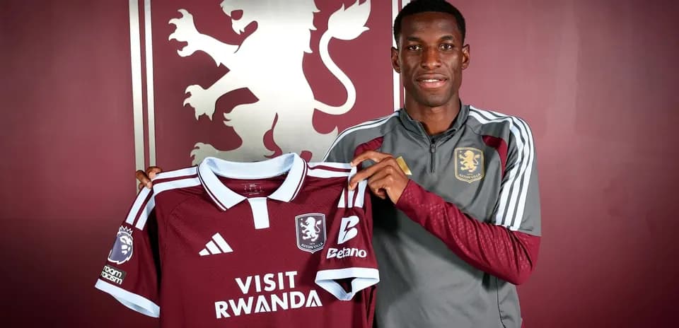 Player holding Aston Villa jersey during signing event
