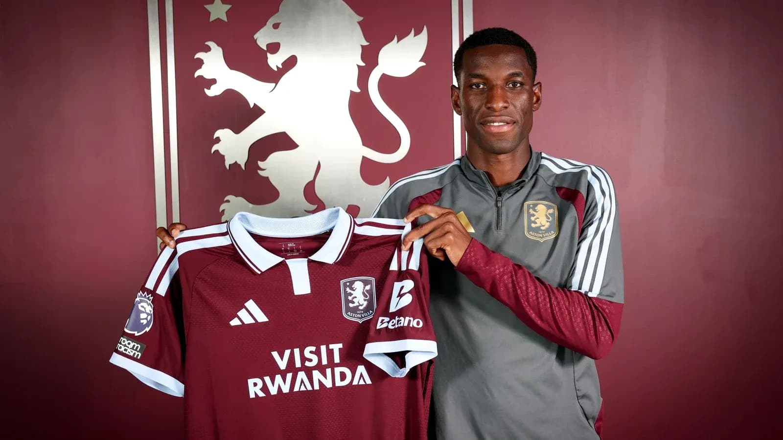 Player holding Aston Villa jersey during signing event