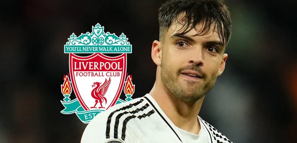 Player in foreground with Liverpool FC logo behind