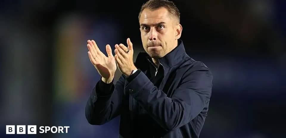 Coach applauding during a match on the sidelines