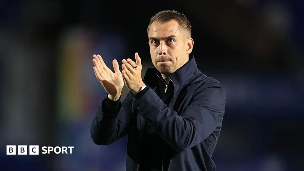 Coach applauding during a match on the sidelines