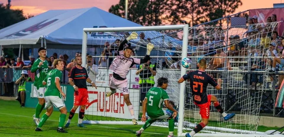 Goalkeeper jumping to save during match