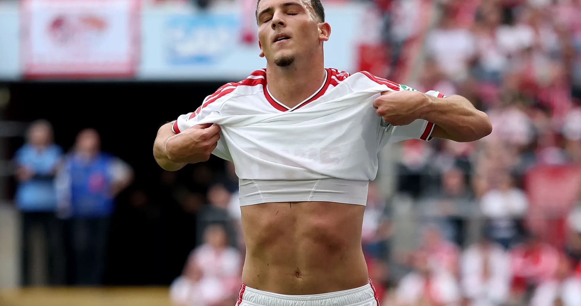 Player lifting shirt during a football match