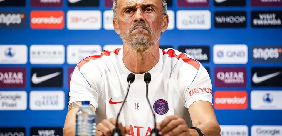 Manager at press conference with sponsor backdrop