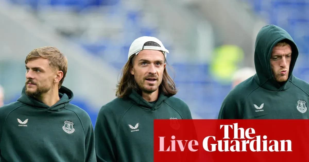 Three players in Everton hoodies walking together
