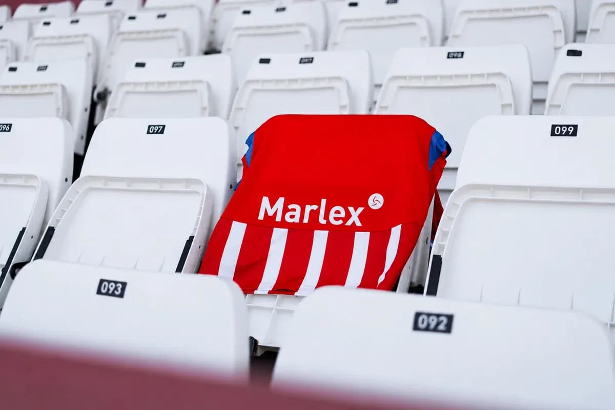 Red jersey with white stripes on empty stadium seat