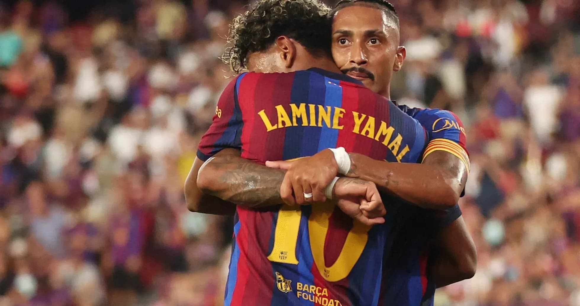 Barcelona players embracing after a goal celebration