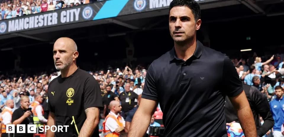 Two football managers walking onto the pitch
