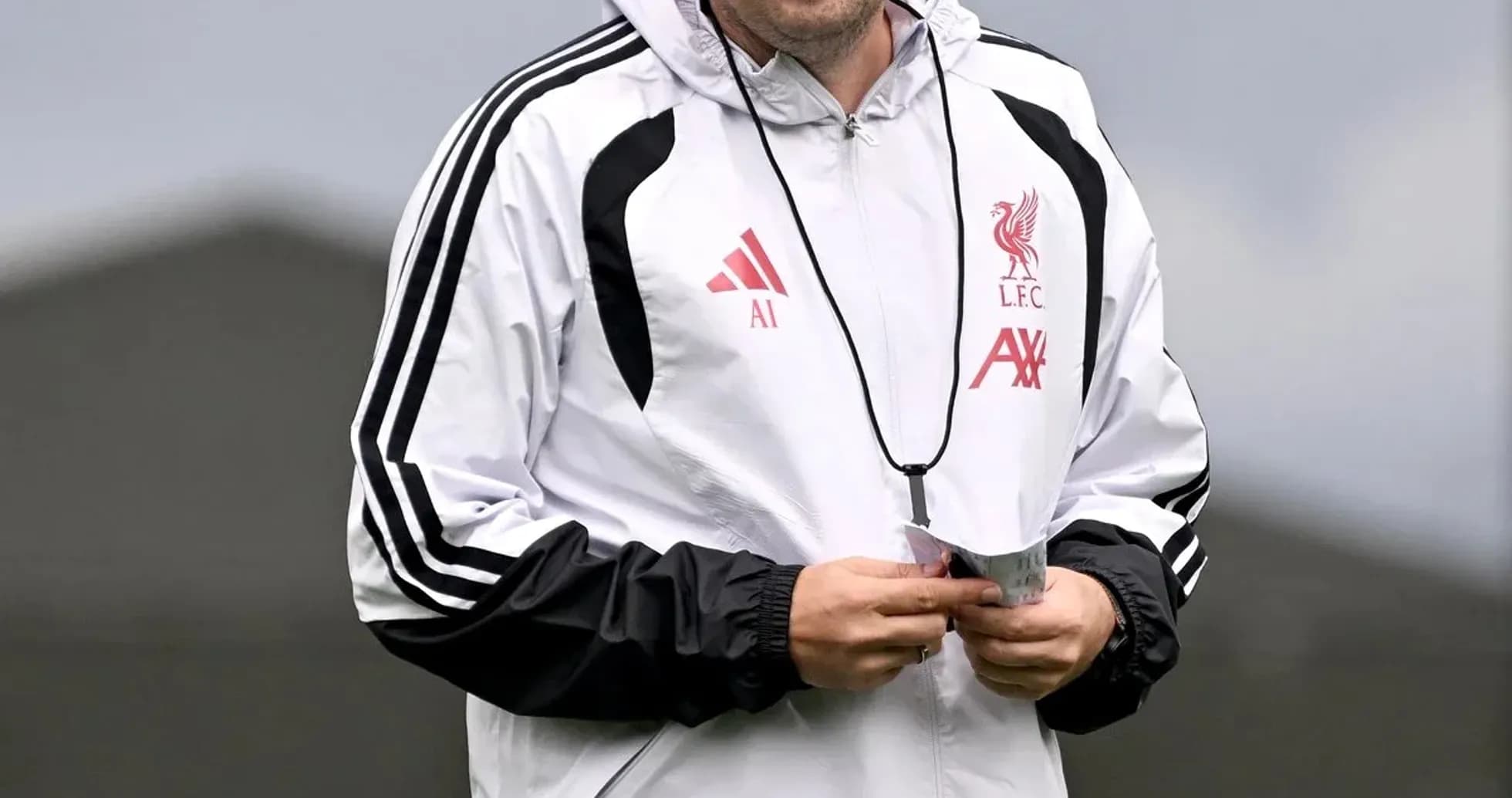 Coach in Liverpool training gear smiling during practice