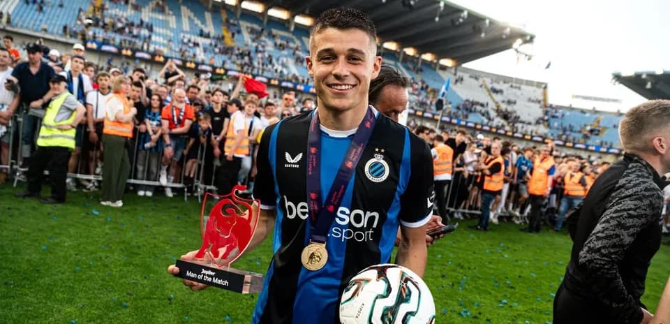 Player holding Man of the Match award on field