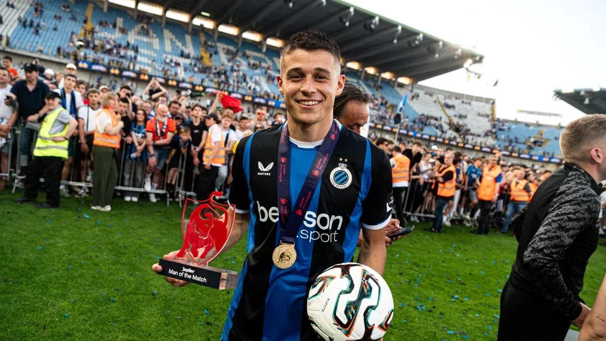 Player holding Man of the Match award on field