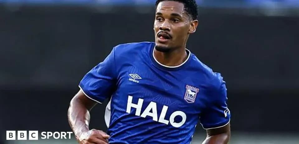 Player in blue jersey running on the pitch