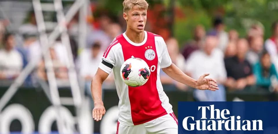 Player in Ajax kit controlling the ball during match