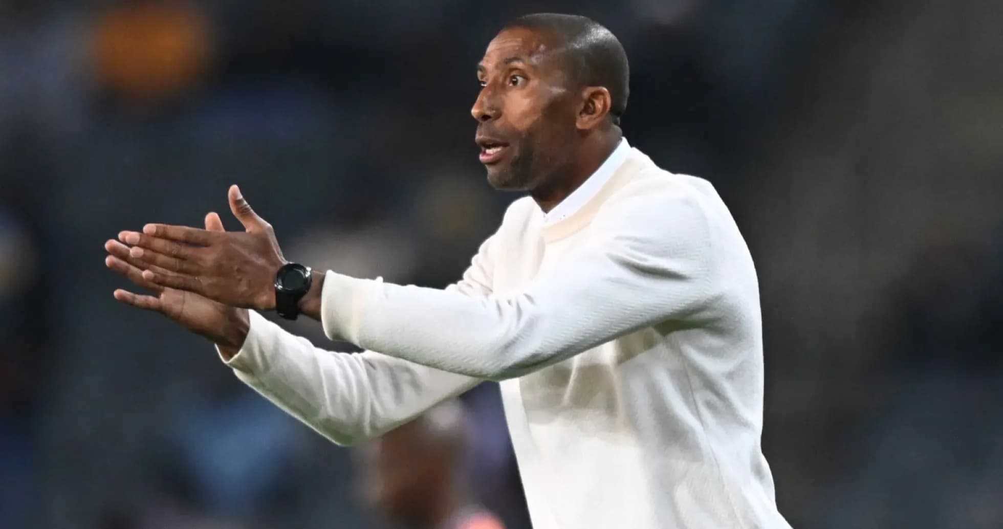 Coach gesturing during a football match on sidelines