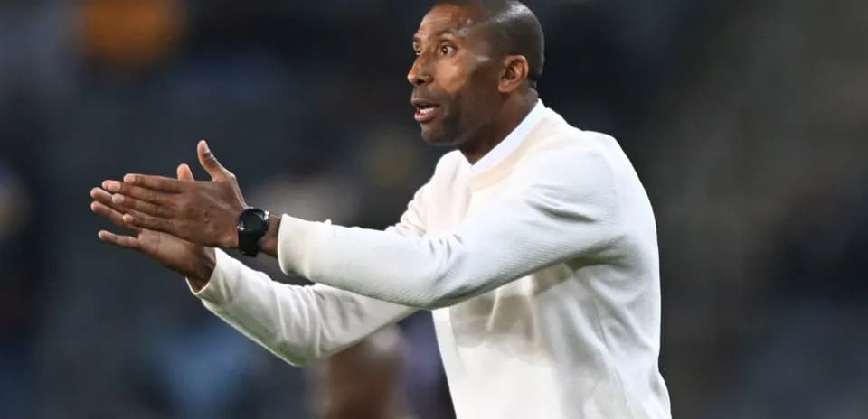Coach gesturing during a football match on sidelines