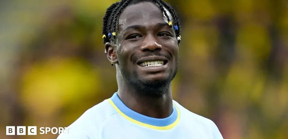Player smiling in team uniform during match