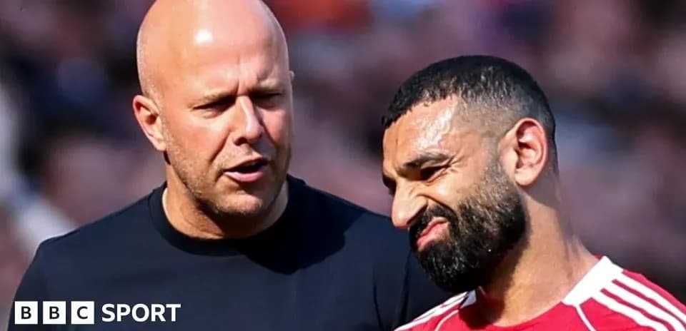 Two individuals discussing on the field after match