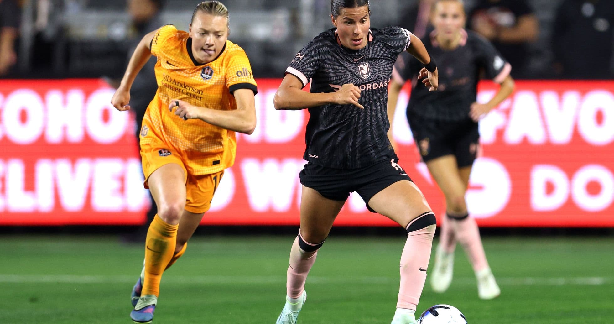 Houston Dash player dribbling past Angel City defender